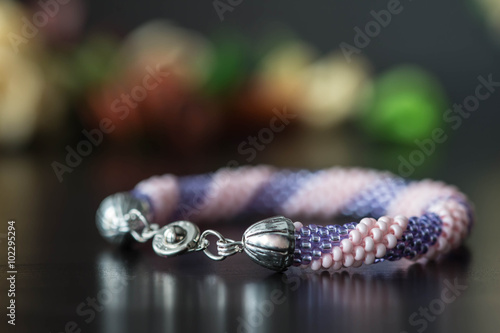 Handmade crochet beaded bracelet from beads of pink and lilac color