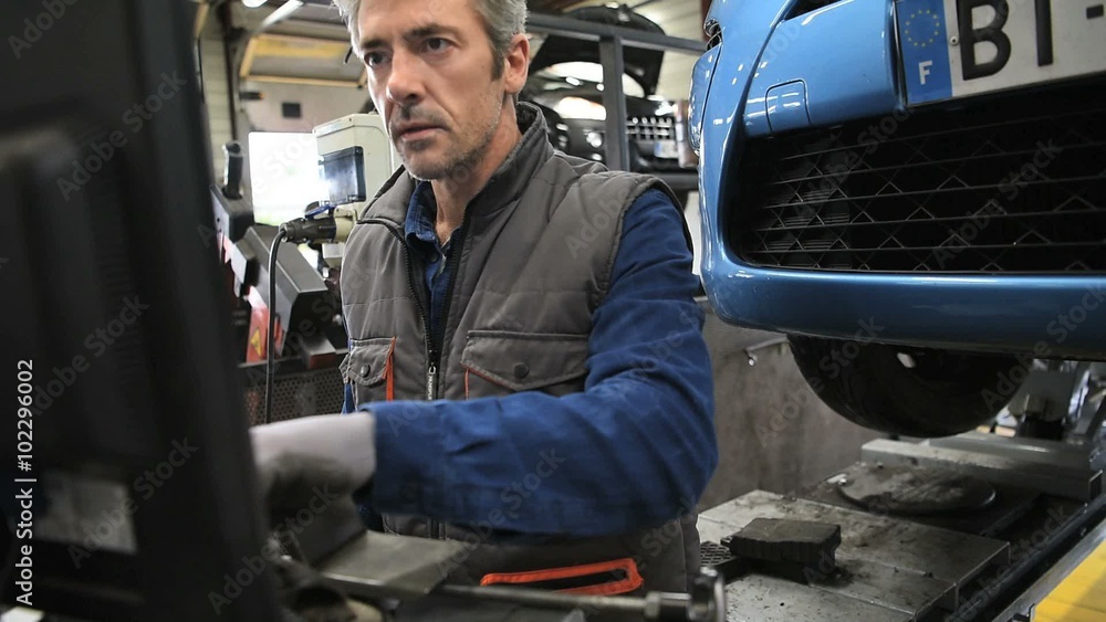 Mechanic working in car repair workshop Mechanic working in car repair workshop