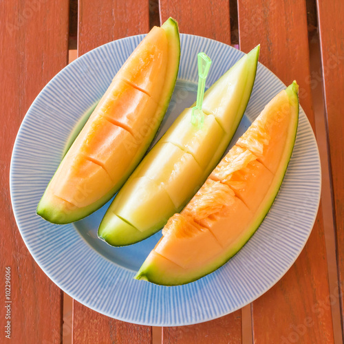 Fresh melon slices on dish