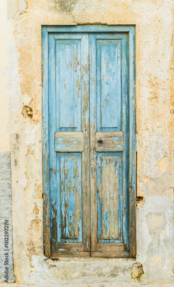 Weathered old blue mediterranean wooden door
