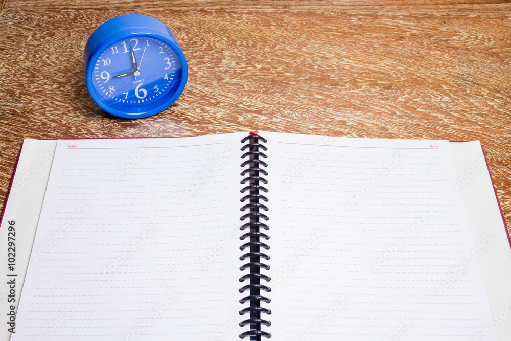 blue alarm clock and notebook blue alarm clock and notebook