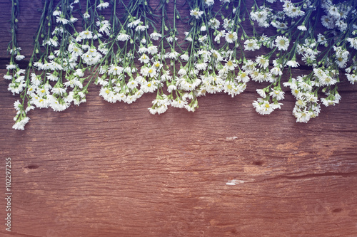 Fototapeta Naklejka Na Ścianę i Meble -  white flowers on vintage wooden background with space