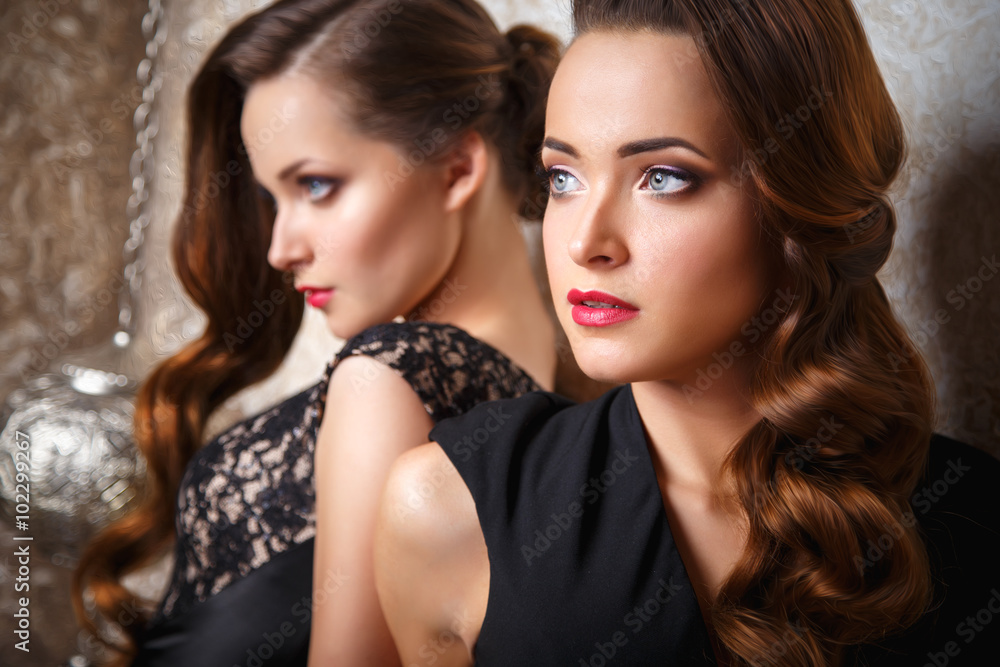 © cherry_d - Portrait of beautiful twins young women in gorgeous evening dresses