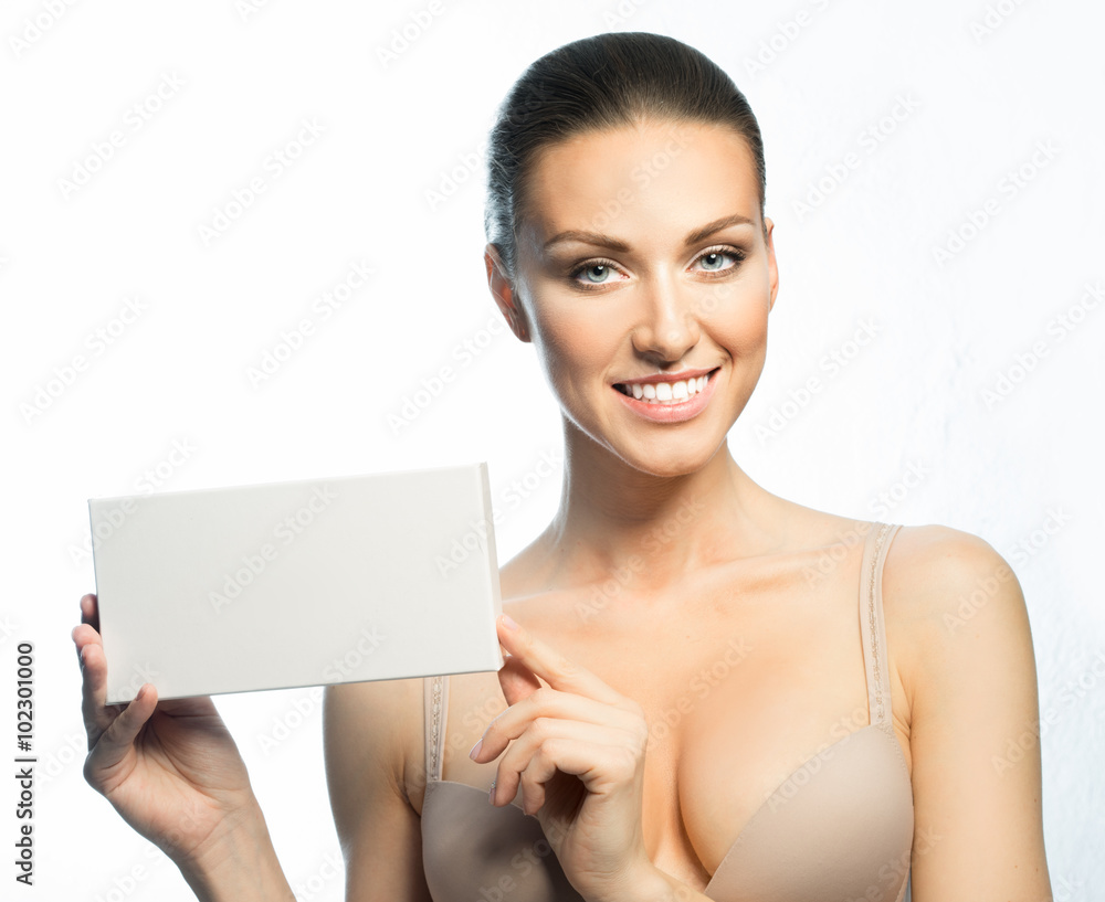 The girl with a beautiful smile, healthy teeth, and promotional card The girl with a beautiful smile, healthy teeth, and promotional card