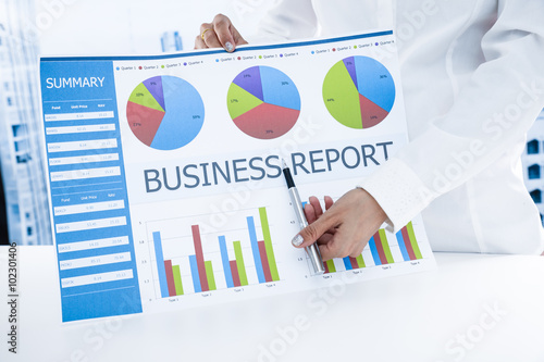 woman hand with pen and business report