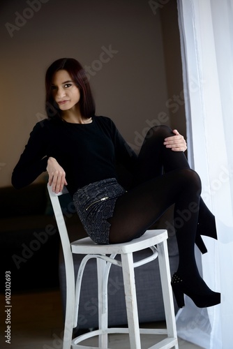 Portrait of  woman sitting on the barstool. photo
