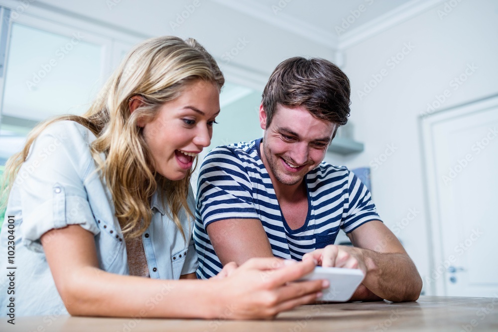 Focused couple using smartphone Focused couple using smartphone