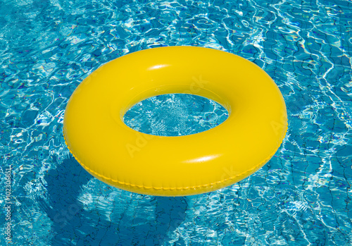 Yellow pool float/ring in pretty blue swimming pool