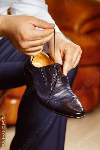 Close up image of a man hand  tiying shoe lace photo