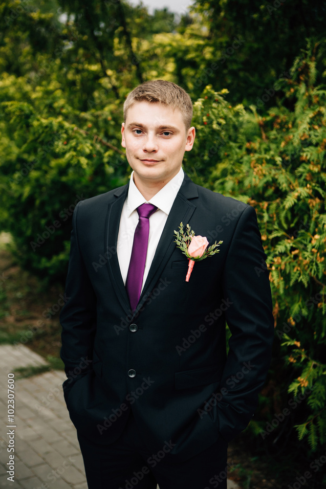 Portrait of stylish groom in park at wedding day Portrait of stylish groom in park at wedding day