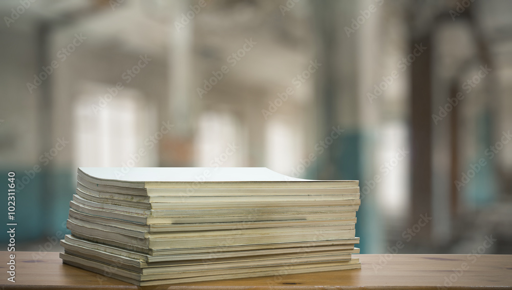 stack of old magazines on wooden table stack of old magazines on wooden table