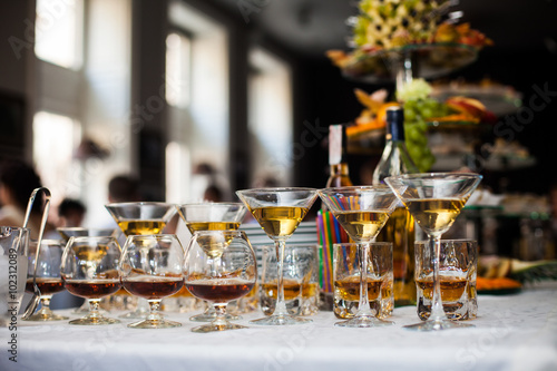 Luxury alcohol wedding table arrangement: cognac, wine and scotc
