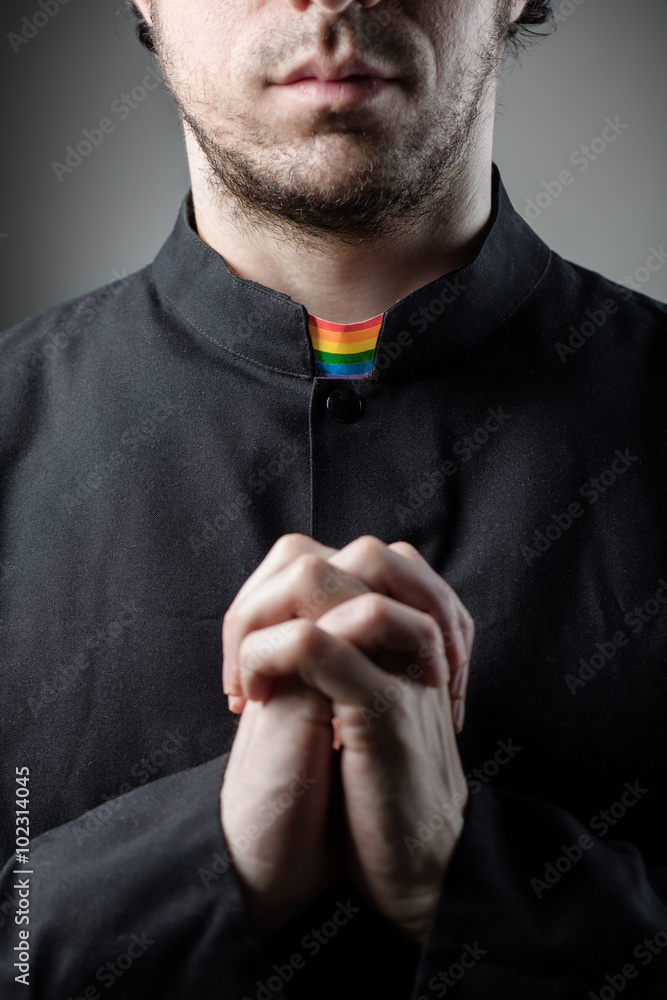 Catholic Gay Priest Praying With Rainbow Collar Stock Photo