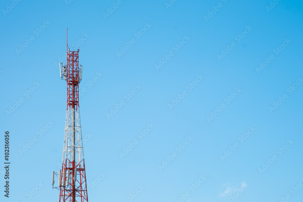 Telecommunication tower with antennas with blue sky background