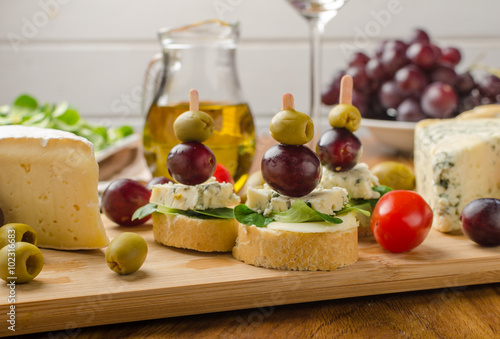 Delicious blue cheese with olives, grapes and salad
