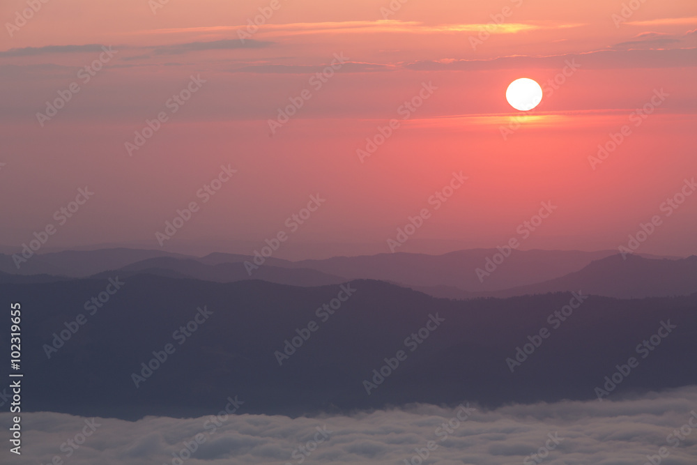 Sunrise over mountains and clouds