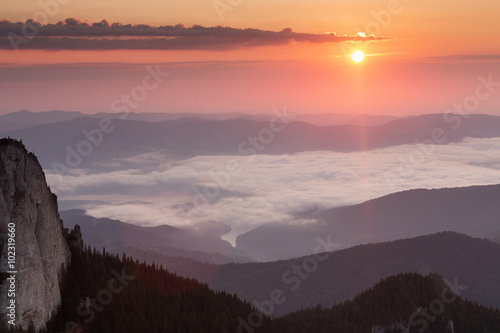 Fototapeta Naklejka Na Ścianę i Meble -  Sunrise over mountains and clouds