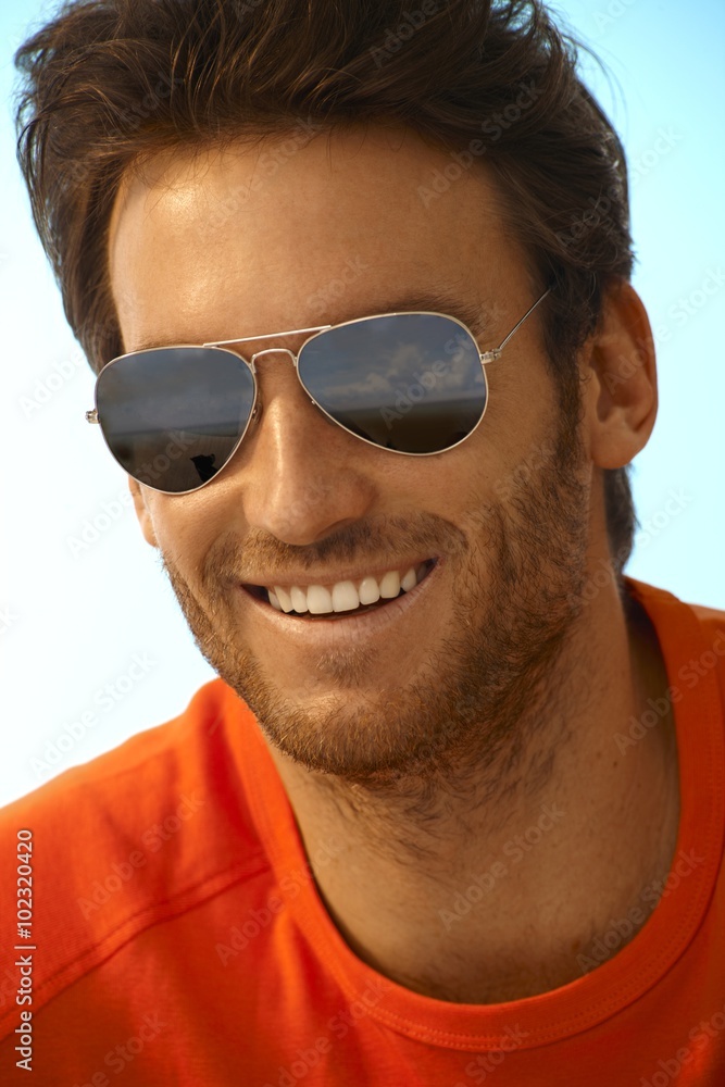 Portrait of happy handsome man wearing sunglasses Portrait of happy handsome man wearing sunglasses