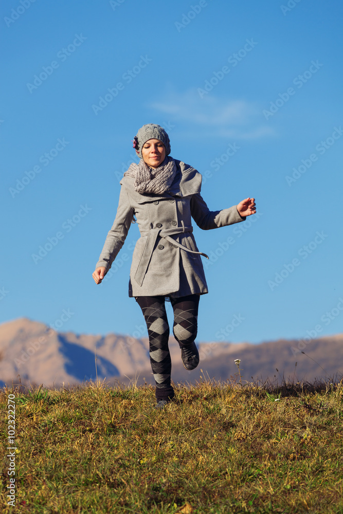 Fototapeta premium Girl in the meadow in the autumn campaign