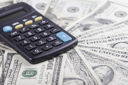 calculator on the background of american dollars banknotes