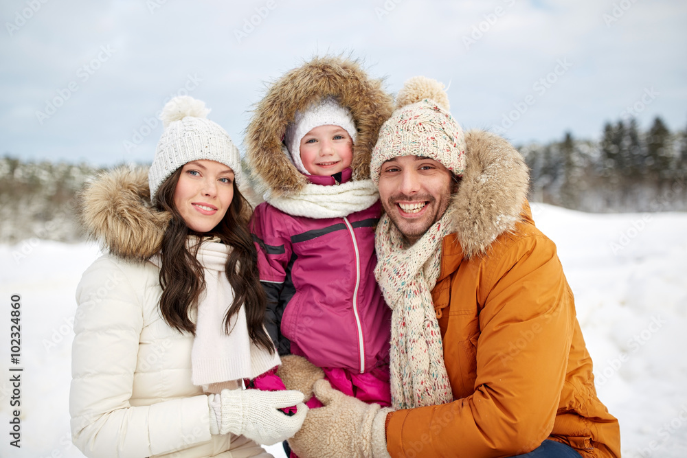 Obraz premium happy family with child in winter clothes outdoors