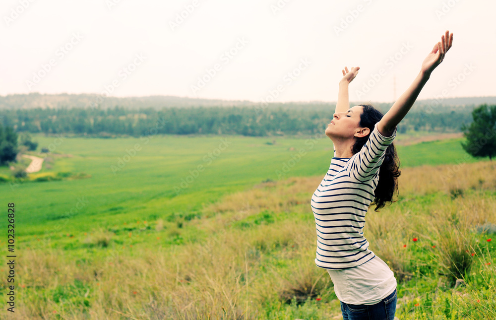 Fototapeta premium Woman with open arms standing outdoors
