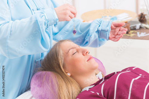 Therapist using pendulum