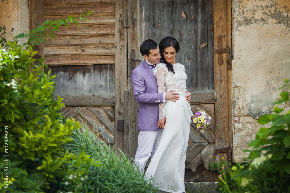 Valentine couple, groom hugging bride from behind, wooden door b Valentine couple, groom hugging bride from behind, wooden door b