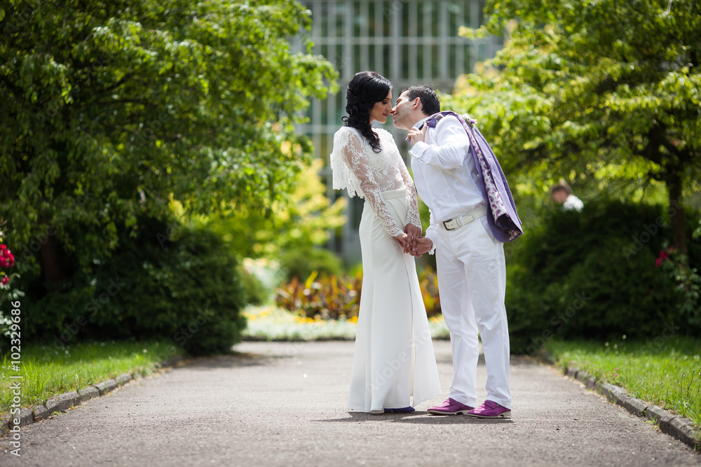 Romantic fairytale married couple in white clothes holding hands Romantic fairytale married couple in white clothes holding hands