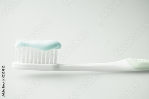 toothbrush with toothpaste in soft color  