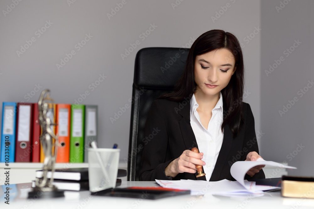 Notary public stamping document with ink stamper. Notary public stamping document with ink stamper.