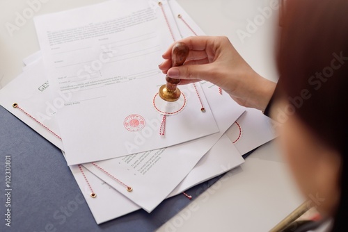 Obraz na płótnie Close-up on notaries public hand stamping document w salonie