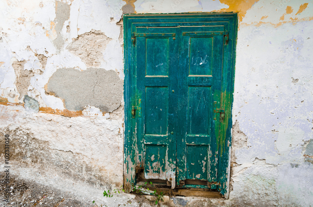 Dilapidated door of a traditional greek house in the village Vourliotes on the aegean island Samos