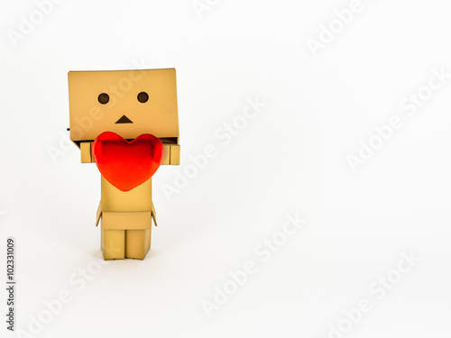 Cute Danbo character lovingly holds out a red heart. photo