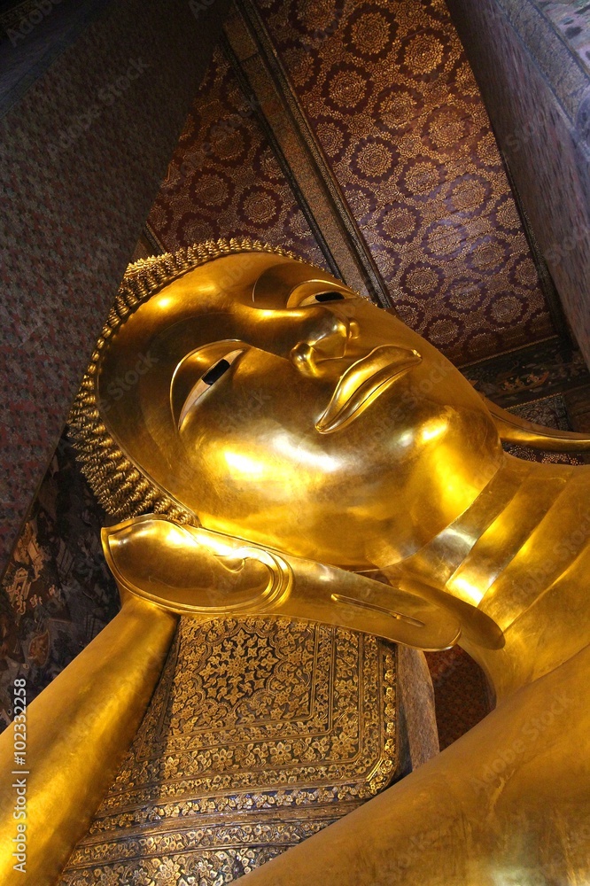 Reclining golden buddha statue in famous Thai temple,  Wat Pho, Bangkok, Thailand