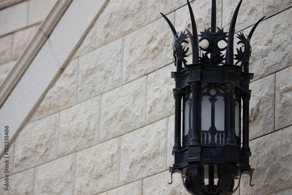 black street lamp and a stone wall