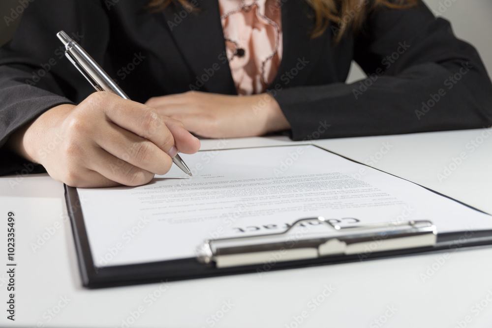 Business woman signing contract document form Business woman signing contract document form
