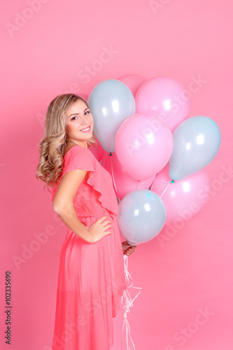 Young beautiful blonde woman with balloons in the studio. Woman holding balloons. Birthday. © Kristina89