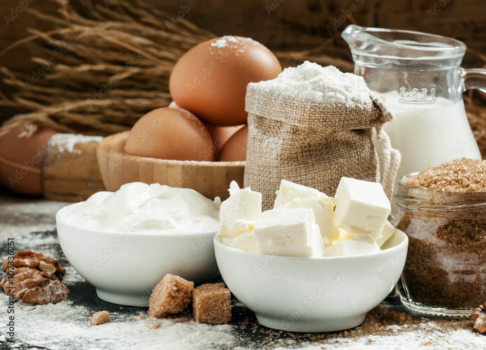 Baking ingredients: milk, butter, flour, sugar, eggs and rolling Baking ingredients: milk, butter, flour, sugar, eggs and rolling