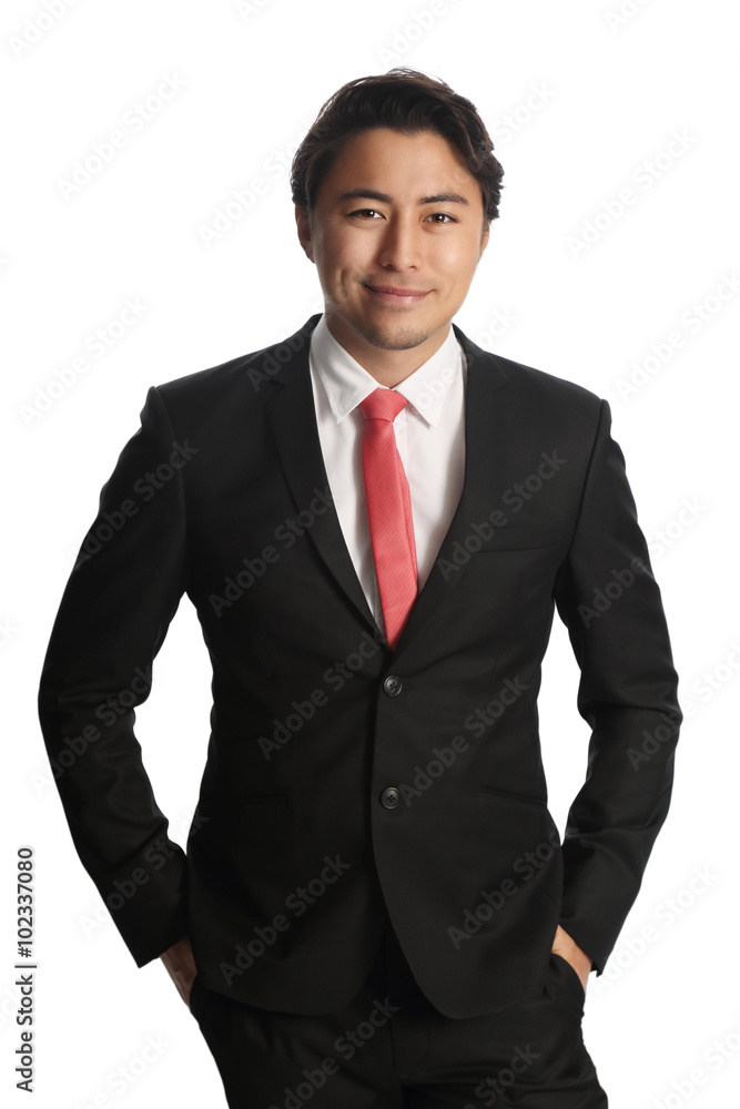 Smiling businessman in a black suit with a red tie. Looking at camera standing against a white background. Smiling businessman in a black suit with a red tie. Looking at camera standing against a white background.