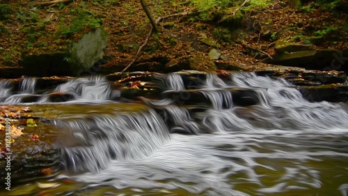 A small waterfall on Brandywine Creek in Cuyahoga Valley National Park Ohio.  Seen here in autumn with colorful fallen leaves. photo