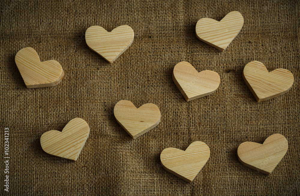 Obraz premium Wooden hearts on sackcloth background