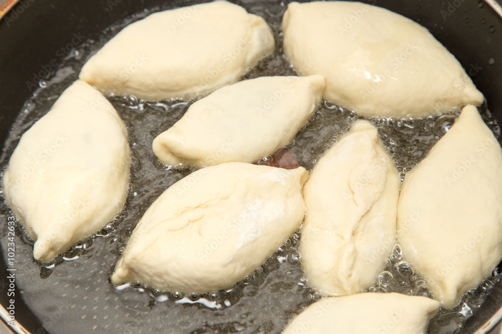 Food patties in a frying pan Food patties in a frying pan
