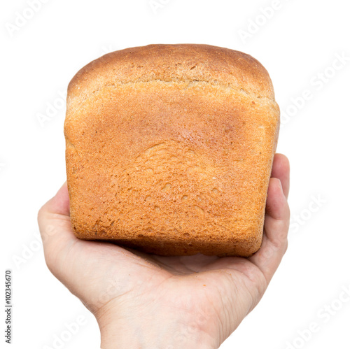 Fresh bread in his hand on a white background