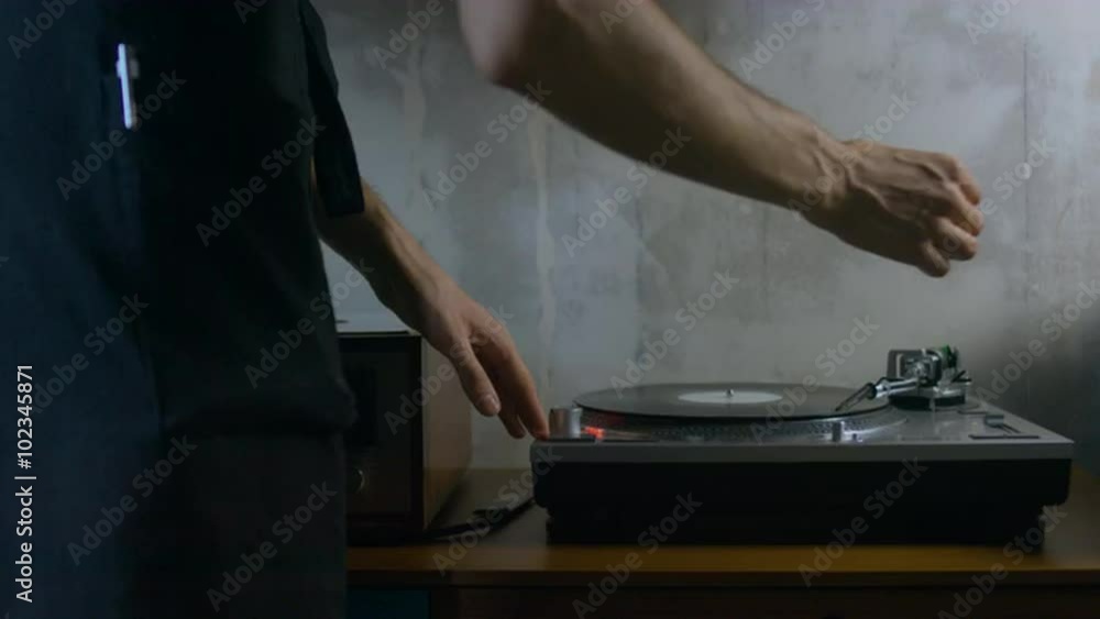 4K cinemagraph - motion photo seamless loop - young adult Caucasian male playing vinyl record on a vintage record player 4K cinemagraph - motion photo seamless loop - young adult Caucasian male playing vinyl record on a vintage record player