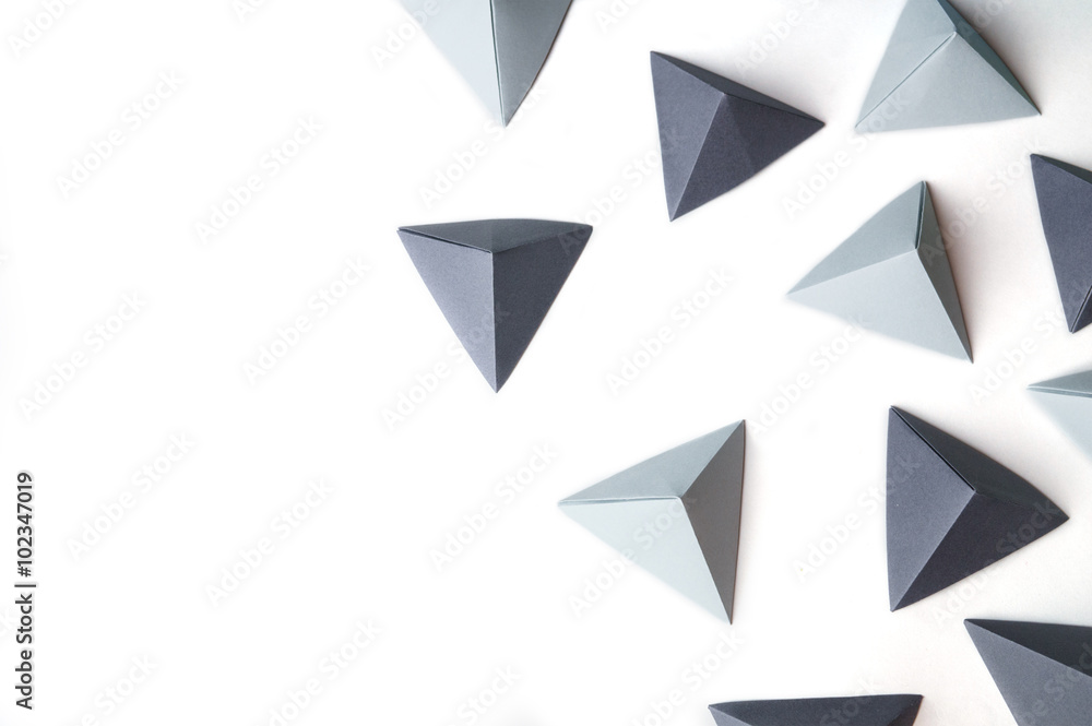 Creative abstract background with black and gray origami pyramids with free copy space on the left side. Great for using in web. Creative abstract background with black and gray origami pyramids with free copy space on the left side. Great for using in web.