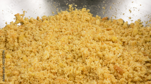 The close up of graham cracker crust mix with melted butter for pie or tart baking.