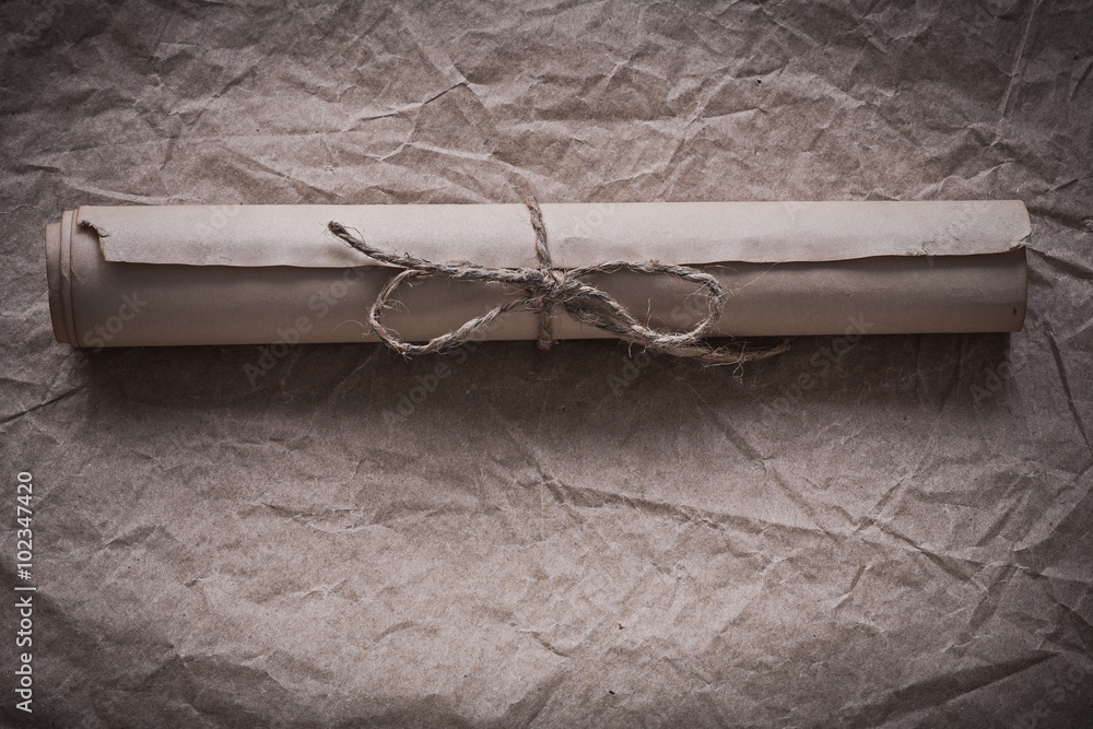 Vintage paper scroll on crumpled wrapping sheet Stock Photo Adobe Stock
