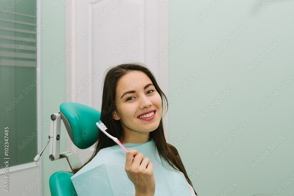 pretty young woman in a dental office.
