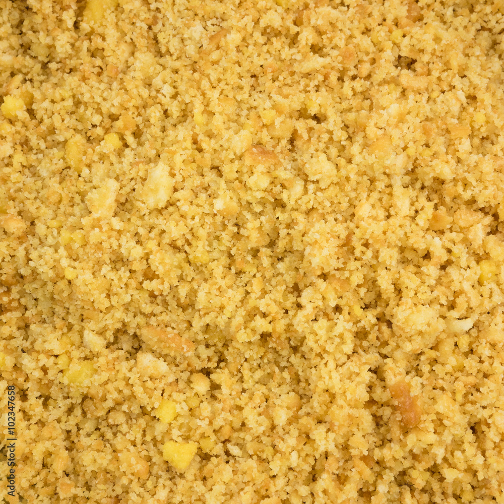 The close up of graham cracker crust mix with melted butter for pie or tart baking. The close up of graham cracker crust mix with melted butter for pie or tart baking.